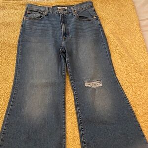 Stylish Blue Flare Jeans with Distressed Accent